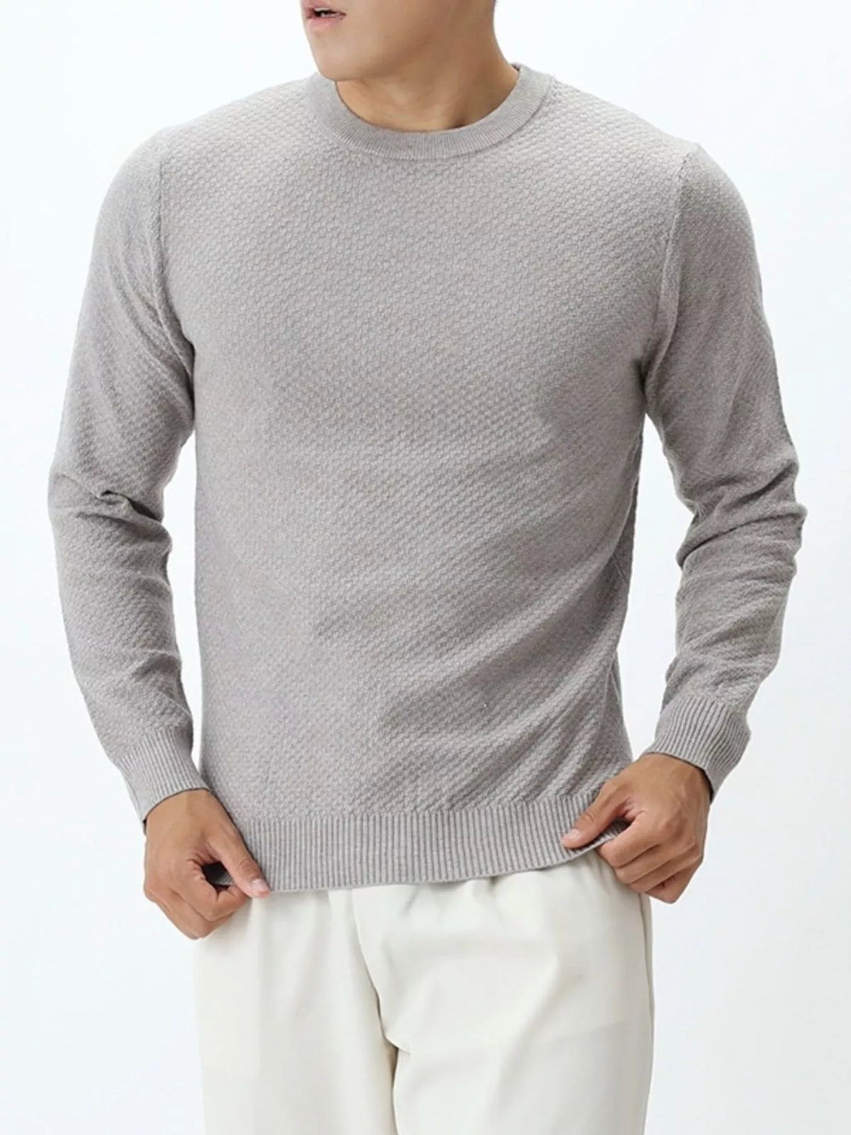 Plus size men's textured crew neck sweater by Trendsi, shown in a close-up of the knit fabric and fit.