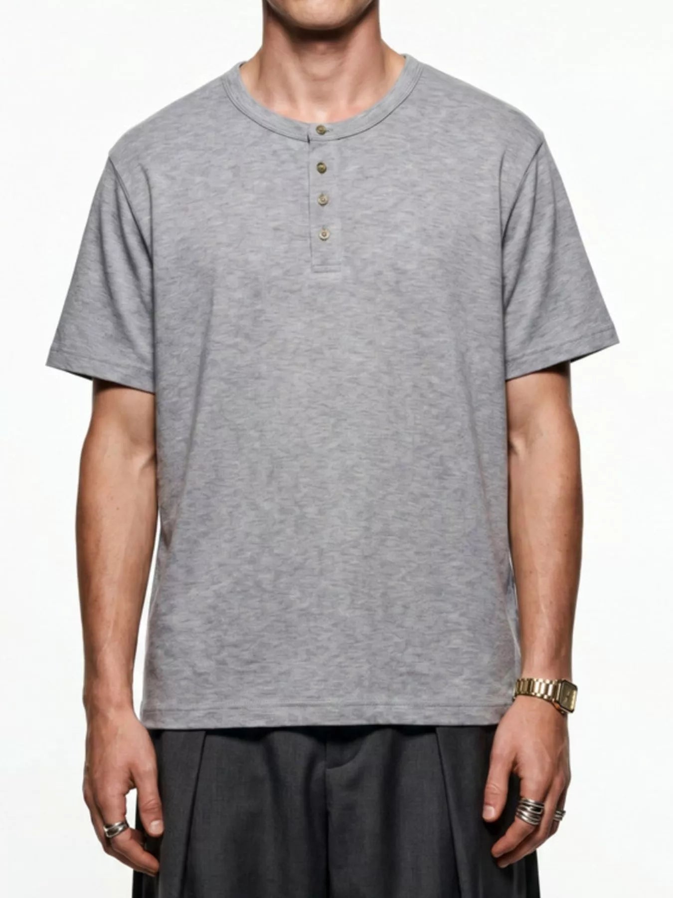 Men's short sleeve Henley T-shirt by Trendsi, featuring a casual fit and buttoned neckline, in a solid color, on a plain background.