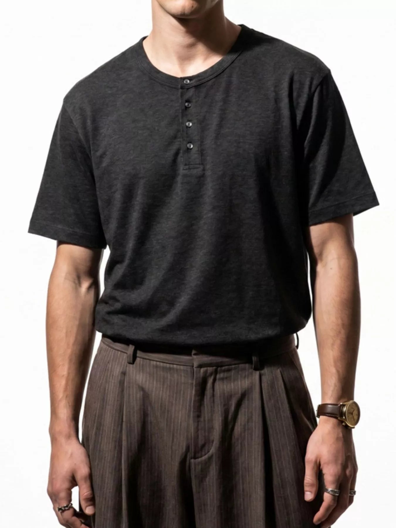 Men's short sleeve Henley T-shirt by Trendsi, featuring a luster finish and casual fit, shown in a natural pose.