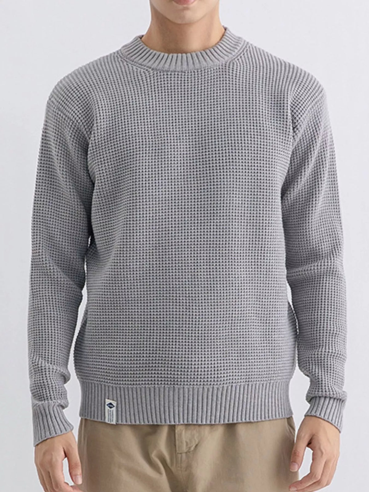 Plus size men's waffle knit crew neck sweater by Trendsi, featuring a textured fabric and classic fit, shown in a neutral color.