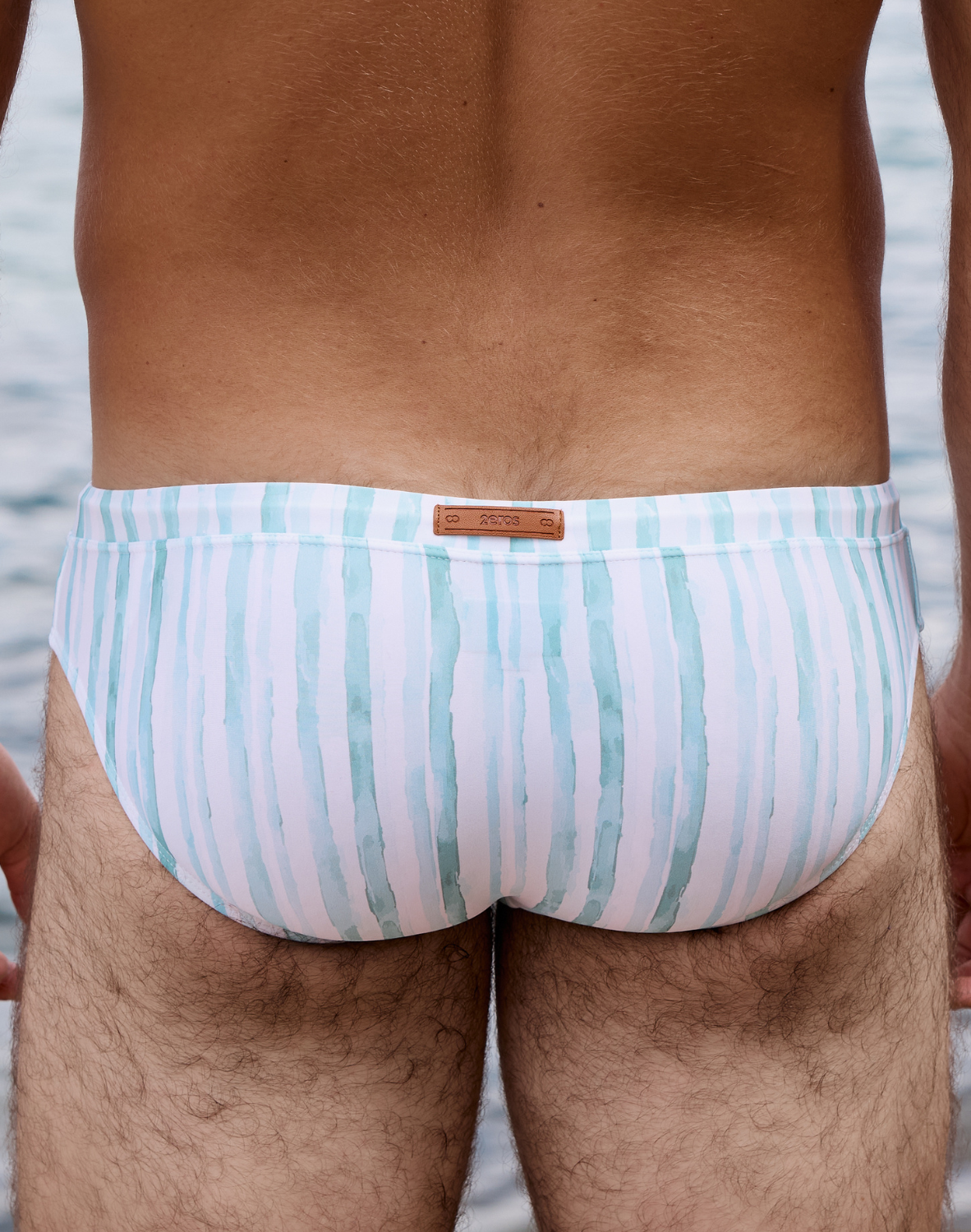 Men's Oceanus swim brief by CITYBOYZ★USA featuring quick-dry fabric and vibrant blue ocean-inspired design.