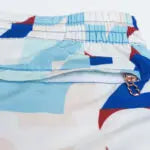 CityBOYZ★USA 2Eros Insignia print swim shorts with bold blue and white design, perfect for beach or poolside wear.