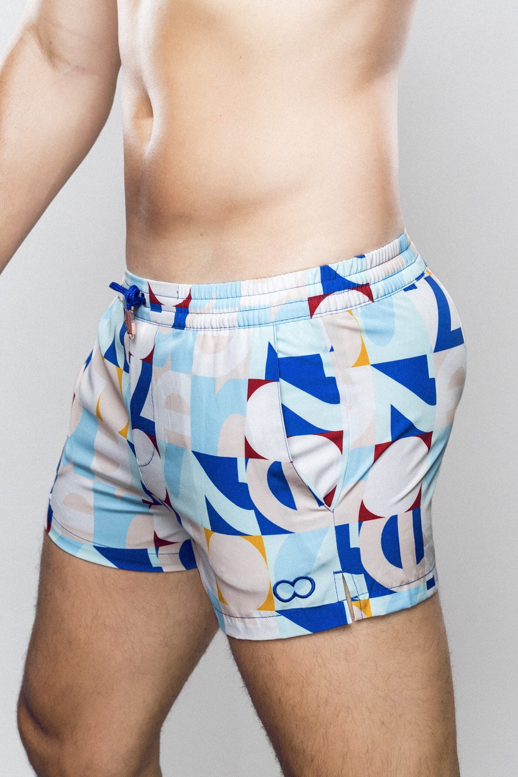 CityBOYZ★USA 2Eros Insignia print swim shorts with bold design and comfortable fit, perfect for beach or pool wear.