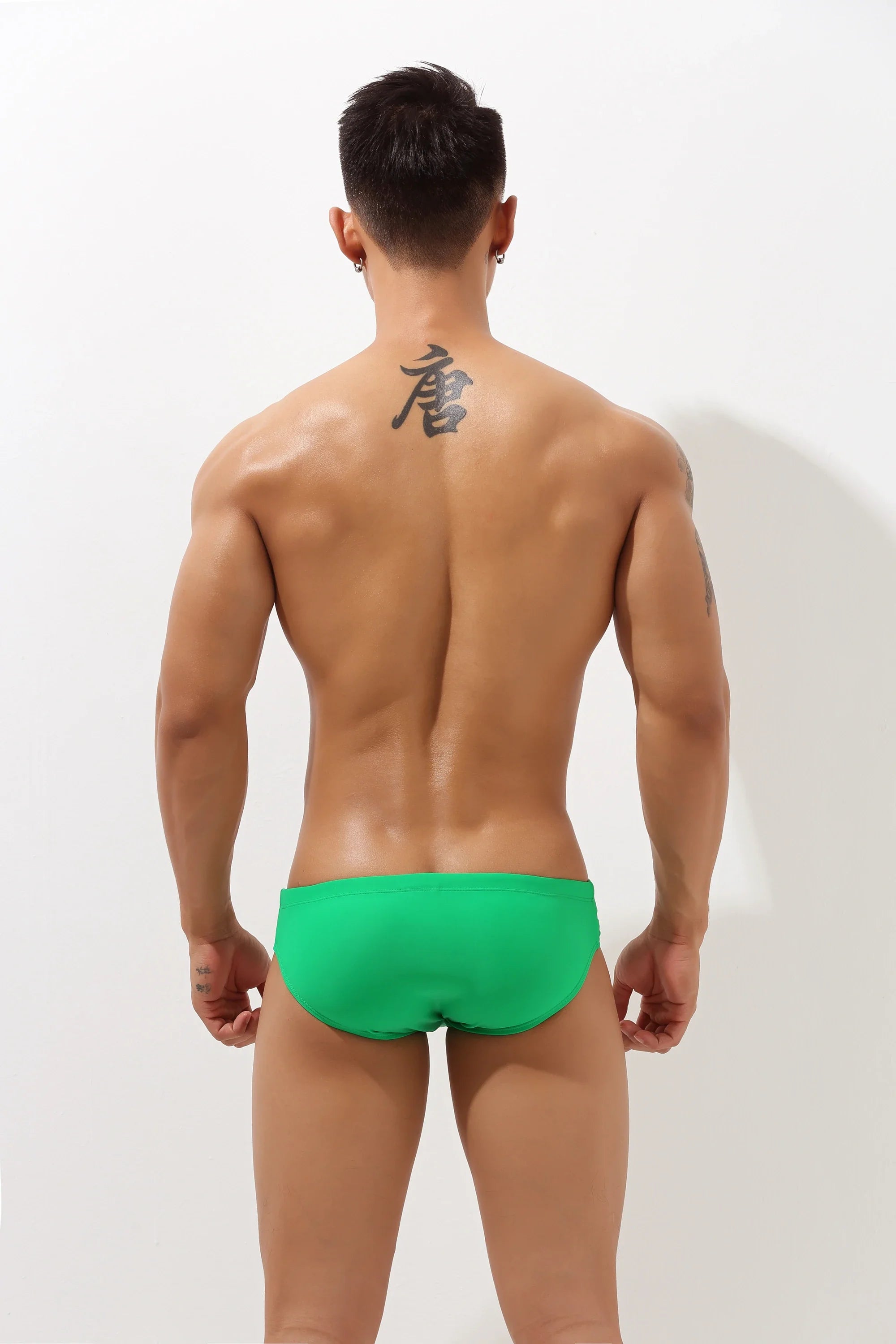 Black 4inme low-rise cutout swim brief with sleek design, featuring side cutouts and a comfortable fit for stylish swimwear.