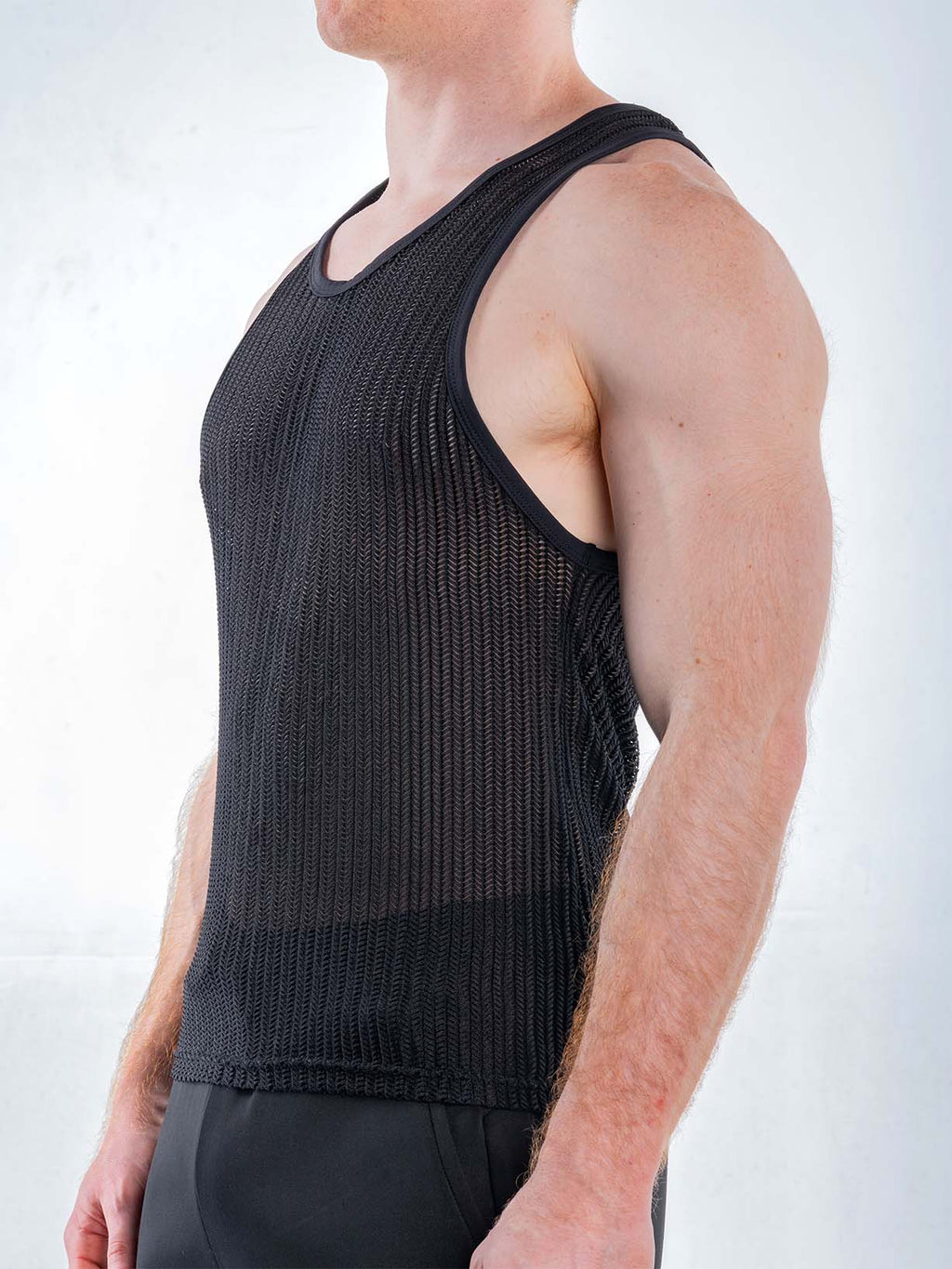 Black FK Sport Captivity mesh tank top by CITYBOYZ★USA shown from the side, featuring breathable fabric and athletic fit.