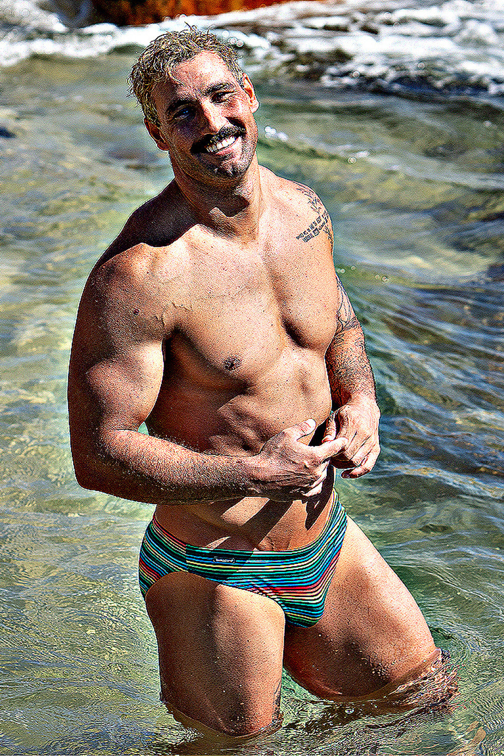 Rainbow swim brief by CITYBOYZ★USA featuring bold rainbow stripes, designed for comfort and style in the water.
