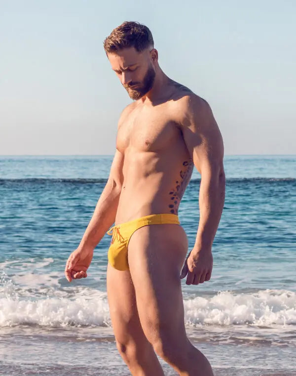 Yellow ripple-textured swim thong by CITYBOYZ★USA featuring a sleek, minimal design and comfortable fit for swimwear.