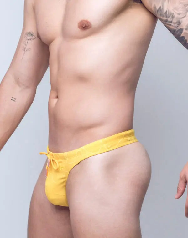 Yellow ripple-textured swim thong by CITYBOYZ★USA featuring a sleek, minimal design perfect for beachwear and swimming.