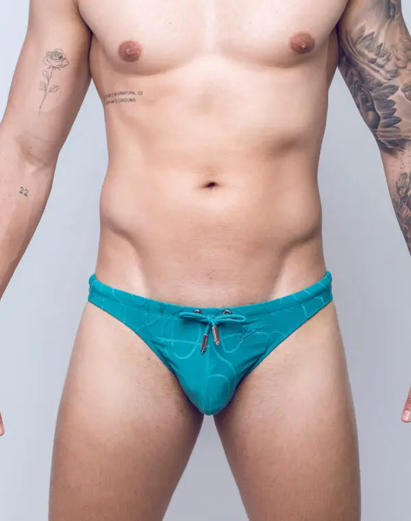 Green ripple-textured swim thong by CITYBOYZ★USA featuring a sleek design and minimal coverage for comfortable beachwear.