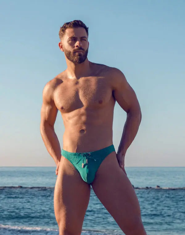 Green ripple-textured swim thong by CITYBOYZ★USA, featuring a sleek design and minimal coverage for comfortable swimming.