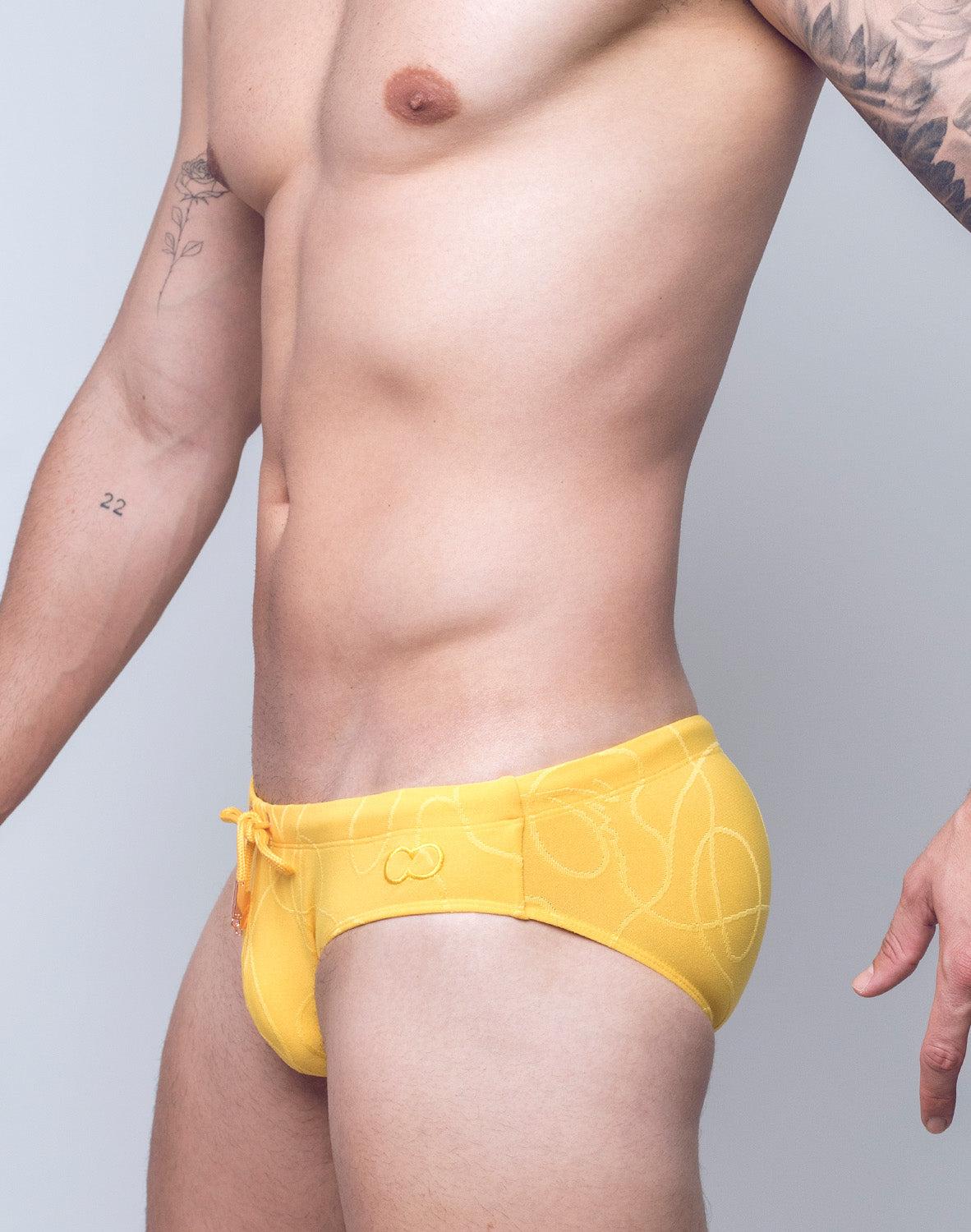 Yellow textured ripple swim brief by CITYBOYZ USA, featuring a sleek design and sustainable fabric for men's swimwear.