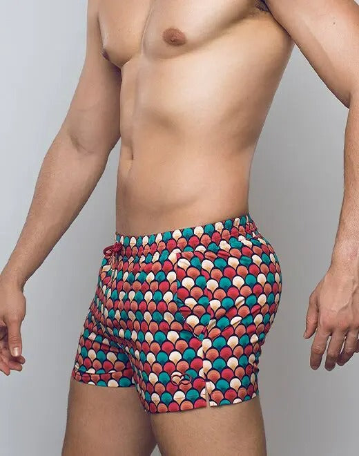 Retro red swim shorts by CITYBOYZ★USA featuring a stylish design, displayed on a model ready for beach or pool.