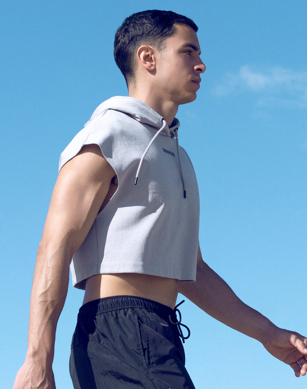 Grey Supawear cropped hoodie by CITYBOYZ★USA, activewear style with a relaxed fit and drawstring hood, shown on a model.