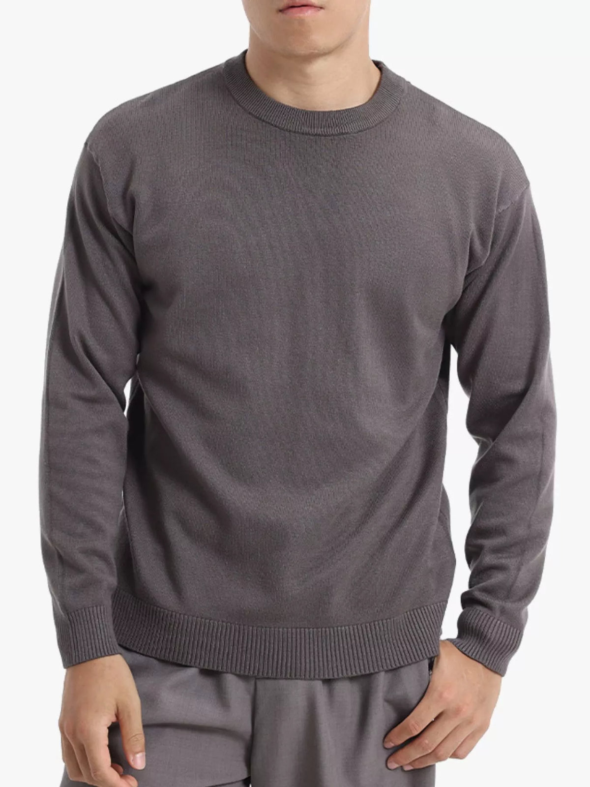 Men's minimalist crew neck sweater with ribbed cuffs by Trendsi, shown in a neutral color, close-up of fabric and fit
