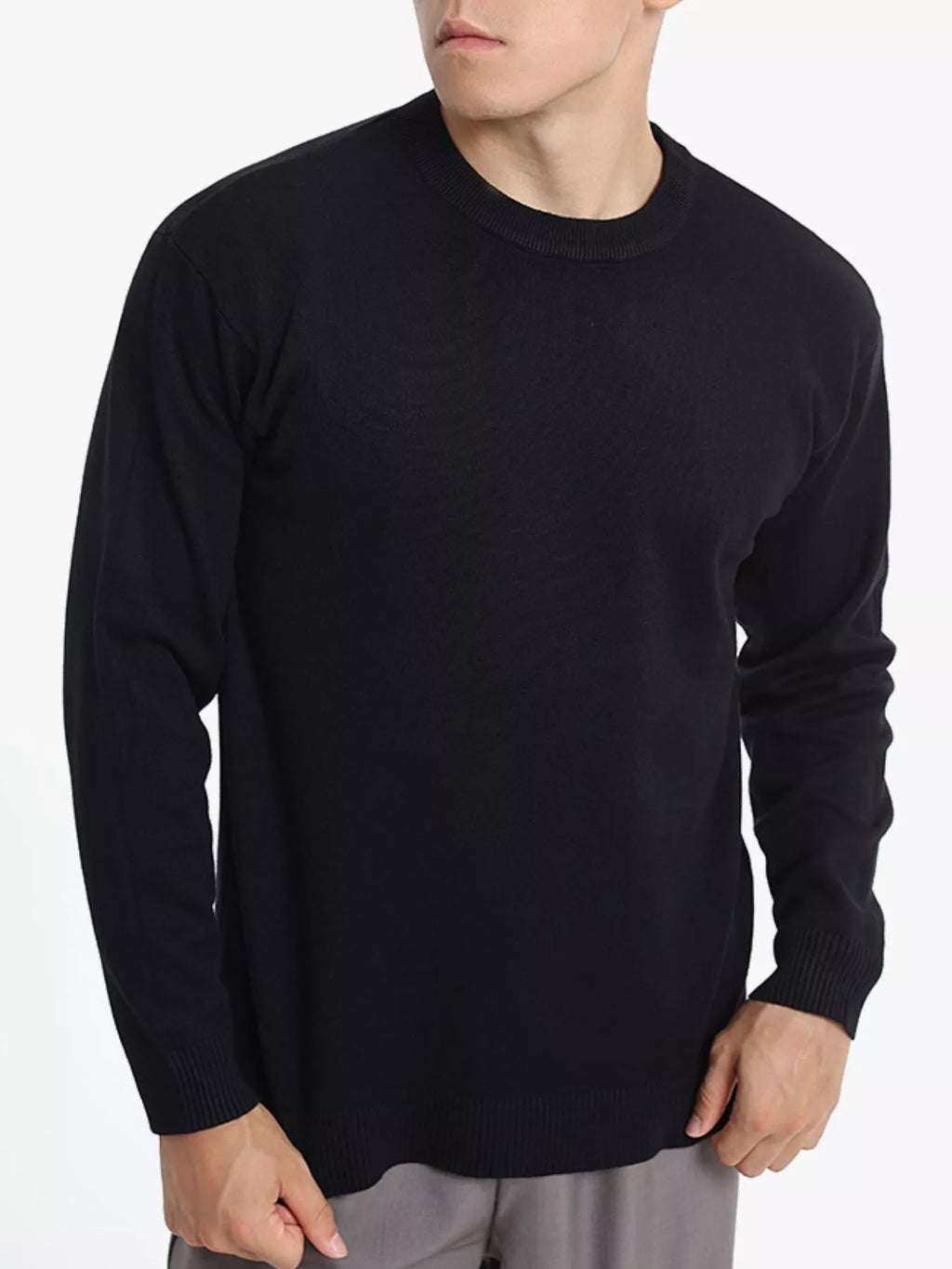 Men's minimalist crew neck sweater with ribbed cuffs from Trendsi, featuring a simple, stylish design in neutral fabric.