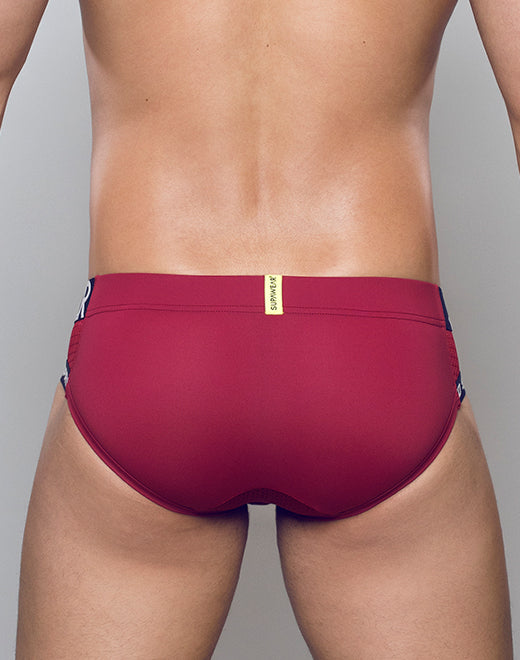 Red Supawear SPR Max Brief underwear by CITYBOYZ★USA displayed on a model, showcasing a sleek fit and vibrant color.
