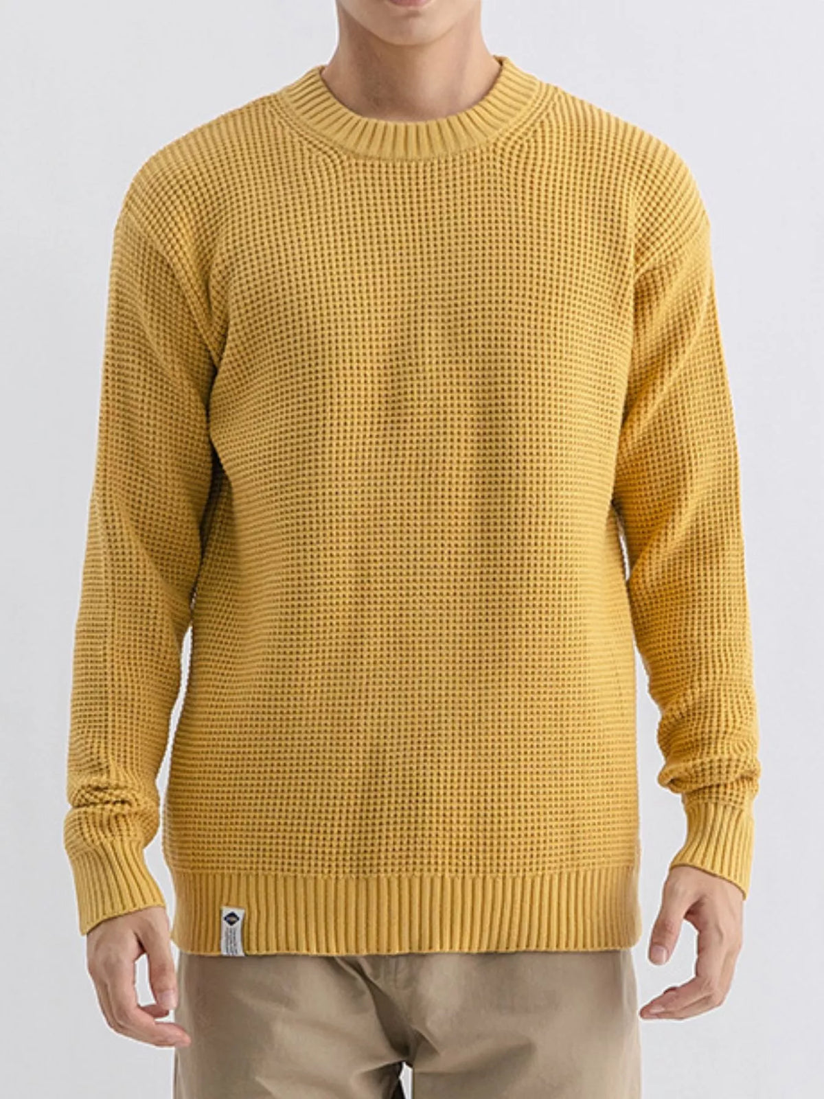Plus size men's waffle knit crew neck sweater by Trendsi, featuring a cozy textured fabric and classic fit in natural colors.