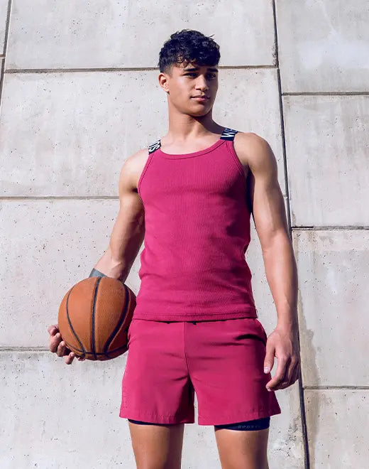 Red Supawear SPR Max athletic shorts by CITYBOYZ★USA with a tank top in the background, showcasing comfortable, sporty design